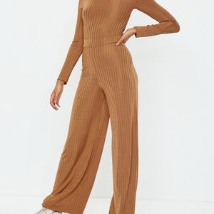 Rust shiny bodysuit and wide leg pants.